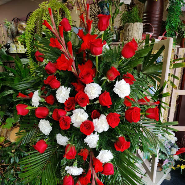 Large standing floral spray with red roses and white carnations