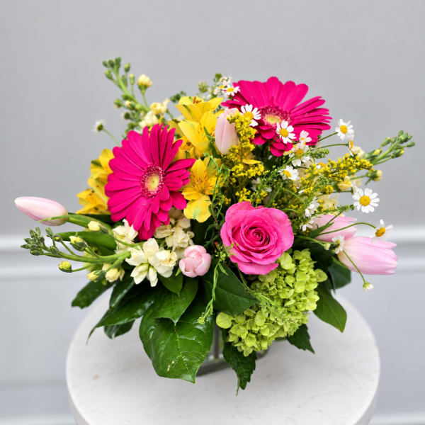 Bright mixed bouquet with pink gerberas, roses, tulips, and yellow flowers