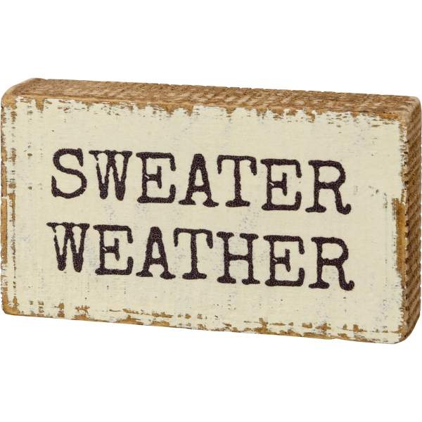 Distressed wooden sign reading "SWEATER WEATHER"