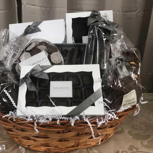 Gift basket with assorted chocolates and cookies in clear wrapping