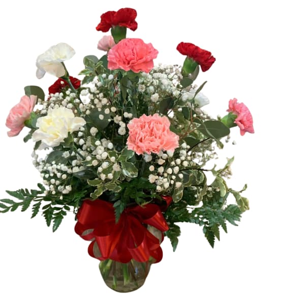Bouquet of pink and red carnations with baby's breath in a glass vase