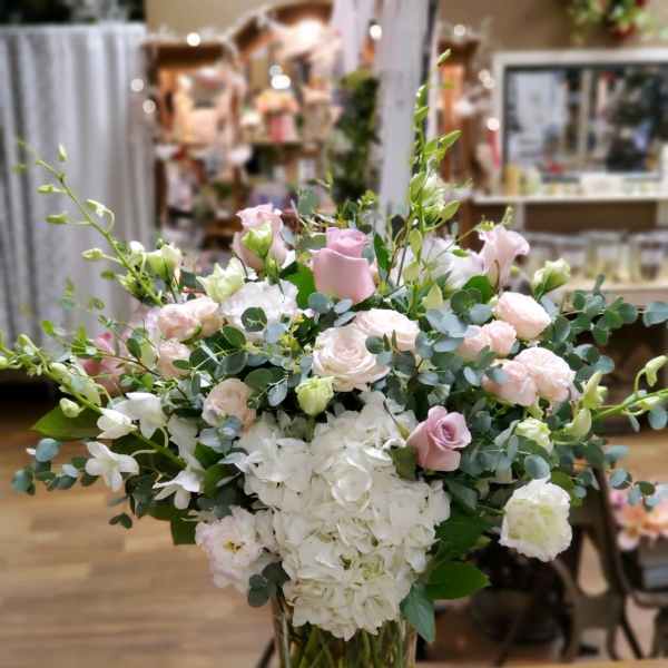 Pink and white floral arrangement in a clear glass vase