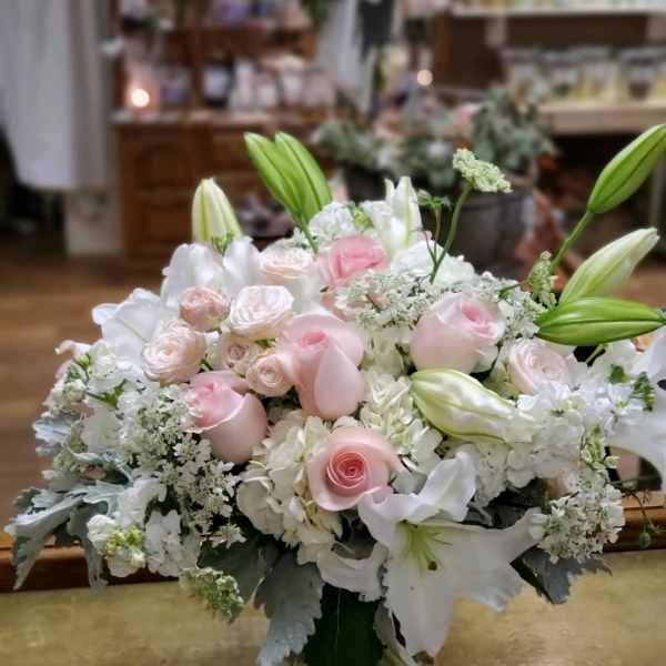 Pink and white floral arrangement in a clear glass vase