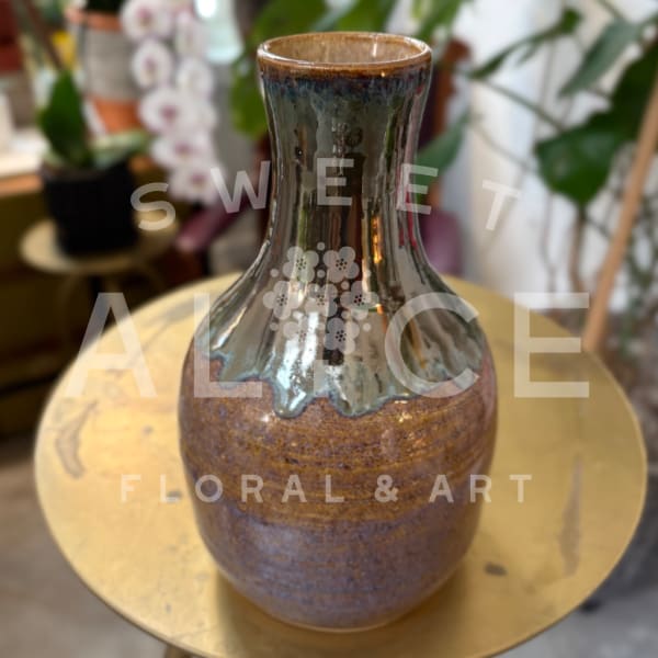 Ceramic vase with a glossy dark neck and brown textured body