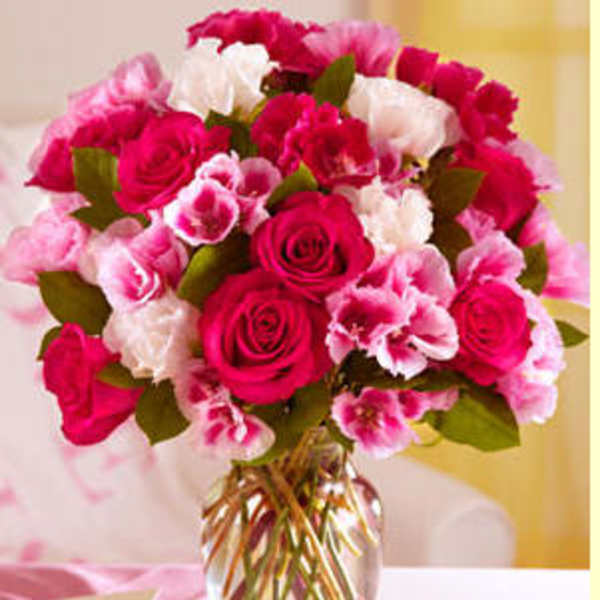 Pink and white rose bouquet in a clear glass vase
