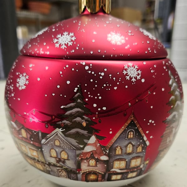 Red Christmas tin with snowy village houses and trees