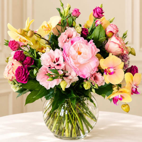 Pink and yellow mixed bouquet in a clear glass vase