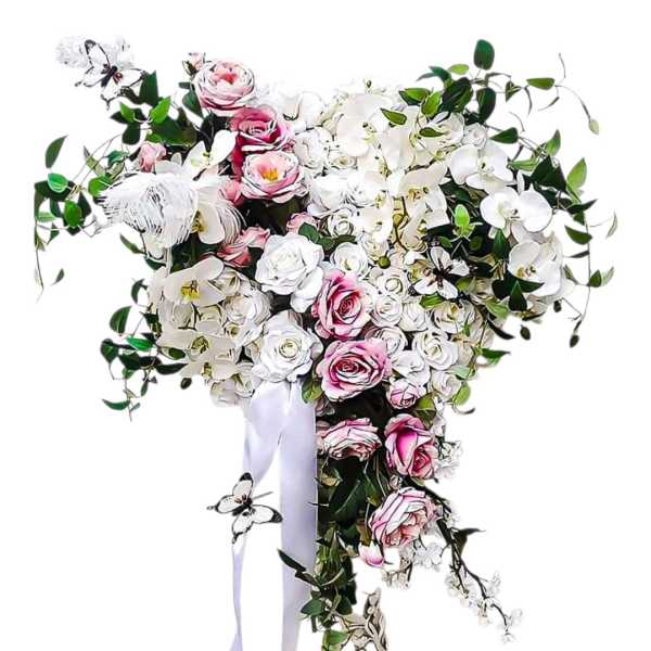 Heart-shaped bouquet of pink and white roses with orchids and trailing greenery