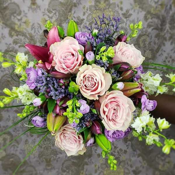 Bouquet of pale pink roses, purple flowers, and lilies