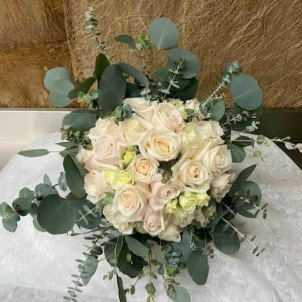 Bouquet of cream roses with eucalyptus greenery