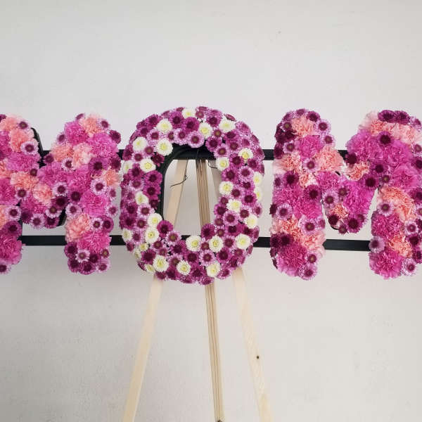 Floral letters spelling MOM in pink and purple flowers