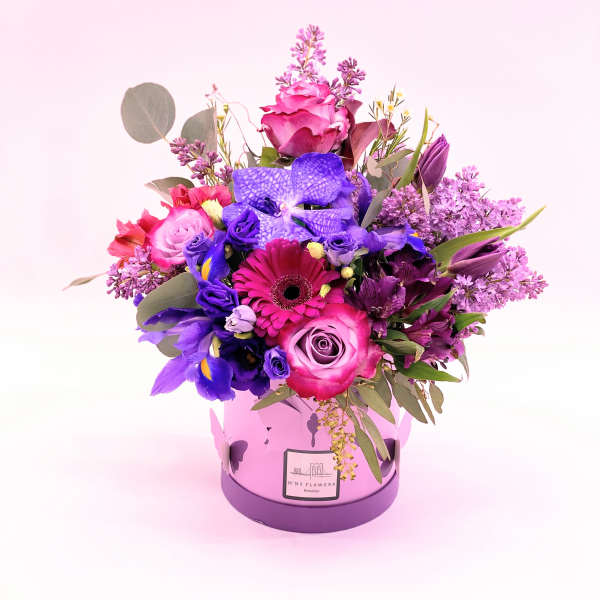 Pink and purple mixed bouquet in a round lavender box