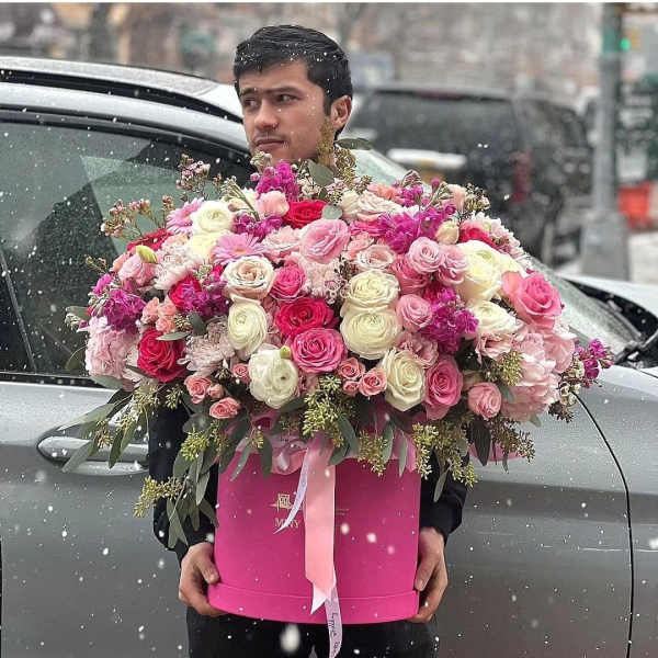 Large pink and white rose arrangement in a pink box