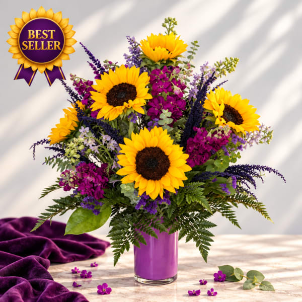Sunflower bouquet in a purple vase with purple accent flowers