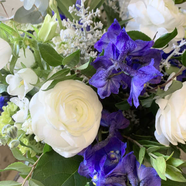 Bouquet of white and purple flowers with green foliage