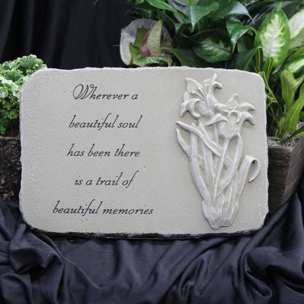Memorial plaque with a floral relief and sympathy quote