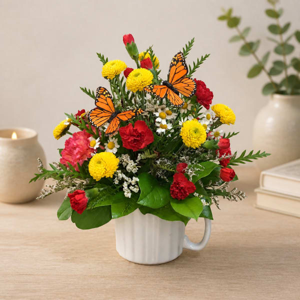 Colorful bouquet in a white mug with butterfly accents