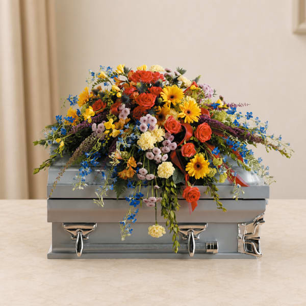 Colorful floral spray on a silver casket
