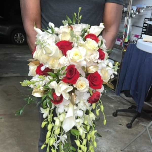 Large bouquet of red and white roses with cascading white orchids