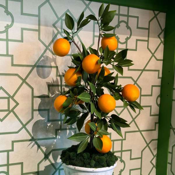 Potted faux orange tree in a white textured planter