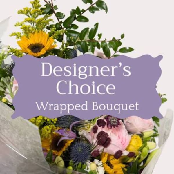 Wrapped bouquet with sunflowers, pink blooms, and mixed greenery