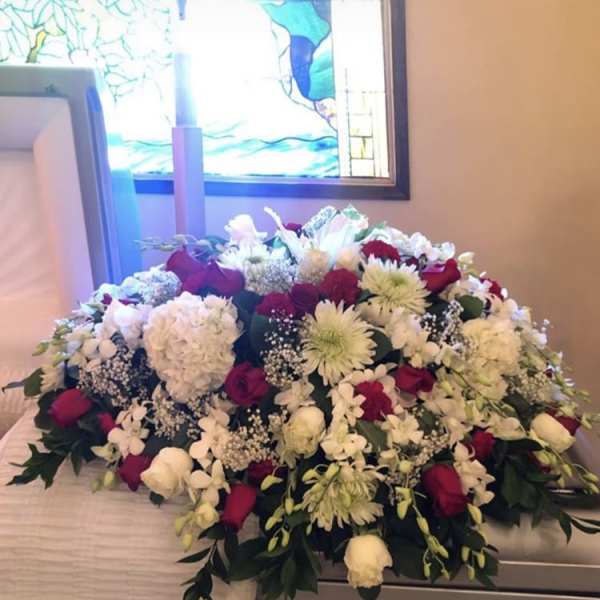 Large casket spray of white and red flowers