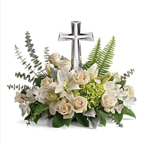 White floral arrangement with a silver cross centerpiece