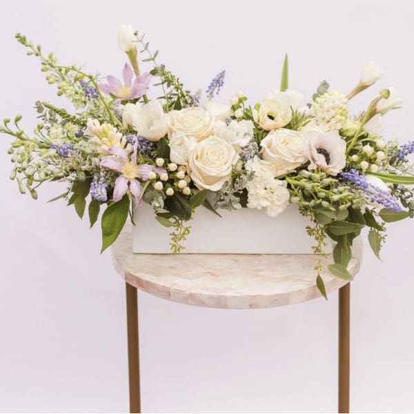 Long pastel floral arrangement in a white rectangular box
