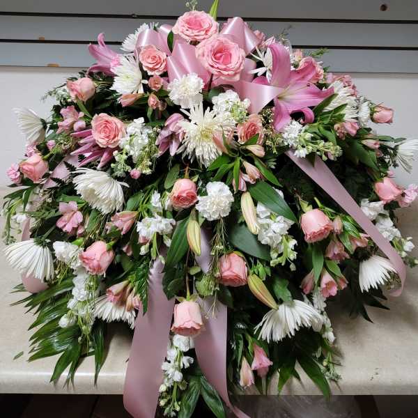Large pink and white floral spray with ribbon accents