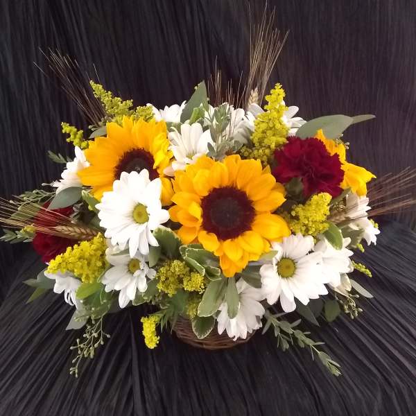 Sunflower and daisy bouquet in a wicker basket