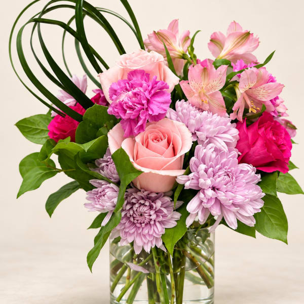 Pink and lavender mixed bouquet in a clear glass vase