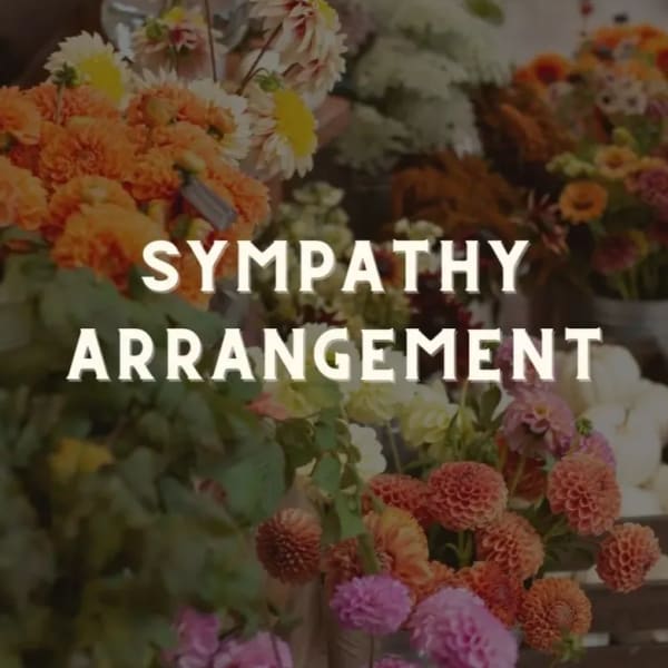 Sympathy arrangement with orange and pink flowers