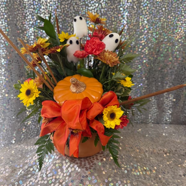 Halloween floral arrangement with a pumpkin, ghost picks, and orange ribbon