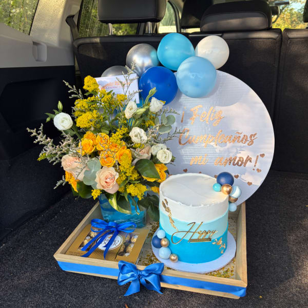 Birthday gift tray with flowers, balloons, cake, and chocolates