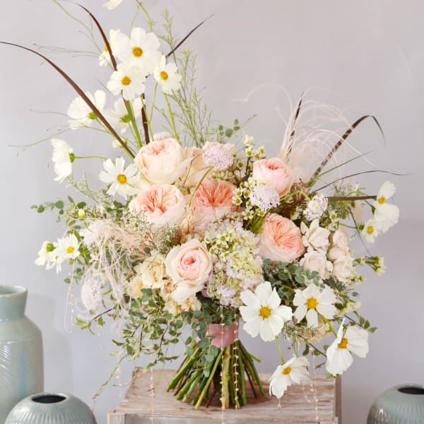 Blush roses and white cosmos in a loose bouquet with airy filler flowers