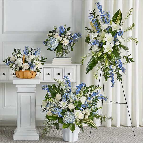 Blue and white floral arrangements in vases and a basket