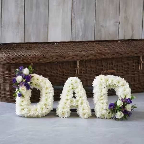 Floral letters spelling DAD with white and purple flowers