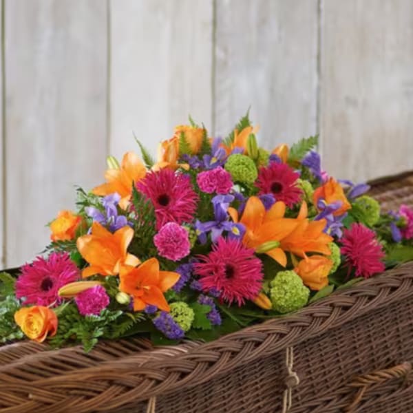 Bright mixed flower arrangement in a wicker basket