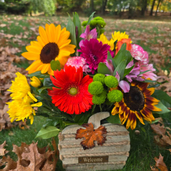 Colorful mixed bouquet with sunflowers, gerbera daisies, and mums outdoors