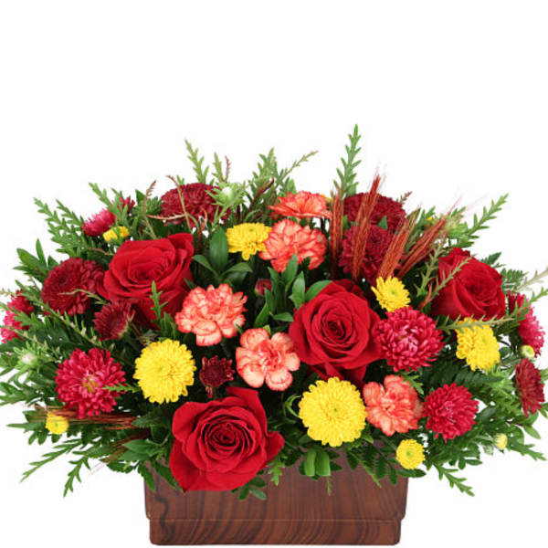 Red roses and mixed mums in a wooden rectangular planter