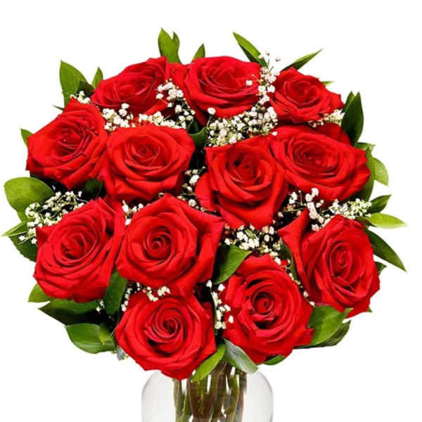 Bouquet of red roses with baby's breath in a clear glass vase