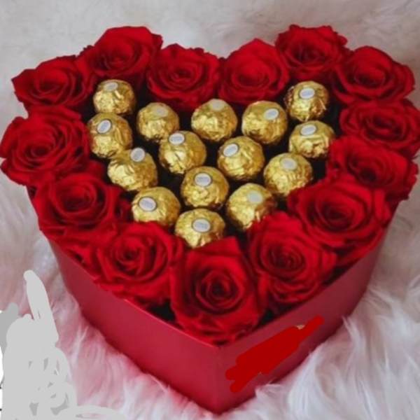 Heart-shaped box of red roses with gold-wrapped chocolates