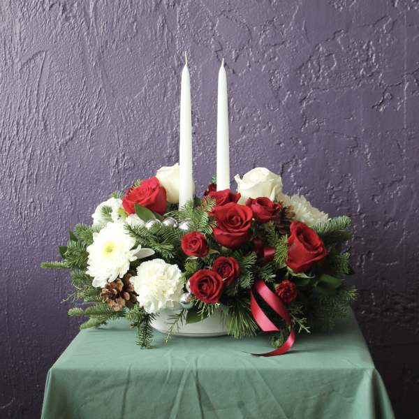 Red and white rose centerpiece with two white taper candles