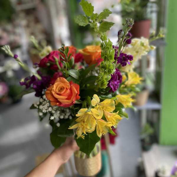 Handheld bouquet with orange roses and yellow alstroemeria