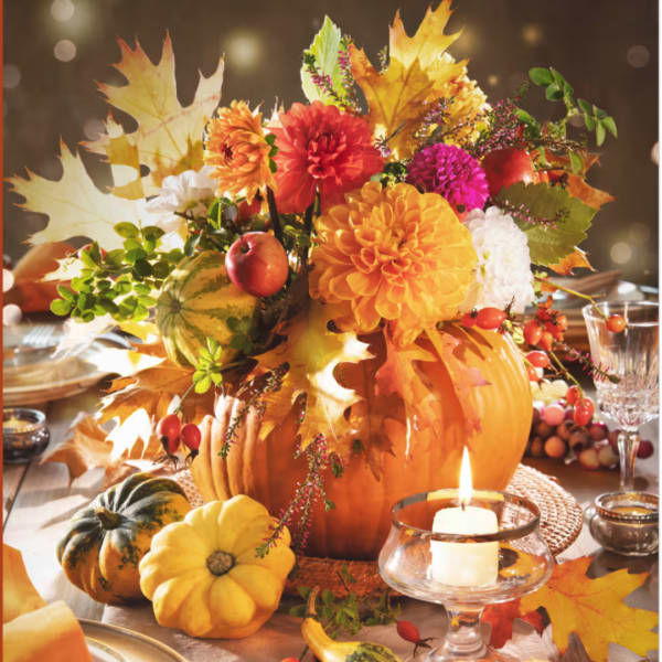 Autumn centerpiece with dahlias, pumpkins, and fall leaves