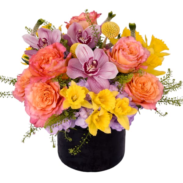 Mixed bouquet of pink roses, orchids, and yellow flowers in a black vase
