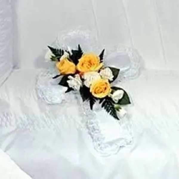 Yellow and white rose corsage on white lace fabric