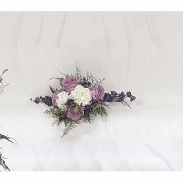 White dress with a small purple and white floral corsage