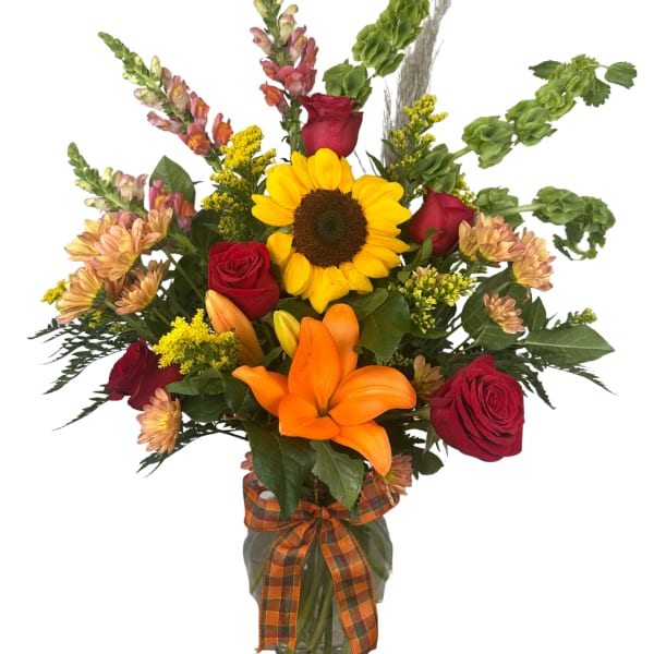 Sunflower and red rose bouquet in a glass vase with an orange ribbon