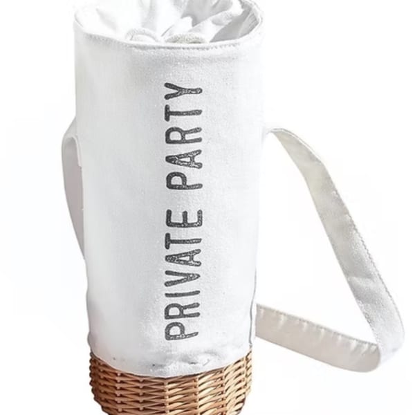 White insulated party cooler bag with a shoulder strap and wicker base